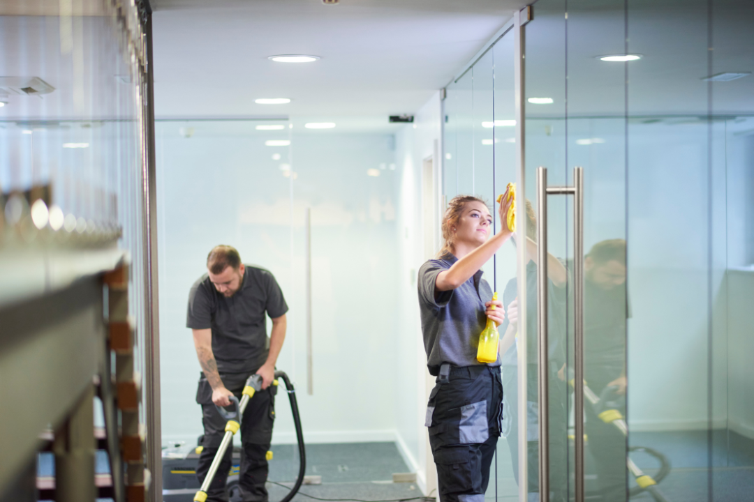 A commercial cleaning team detailing a modern office